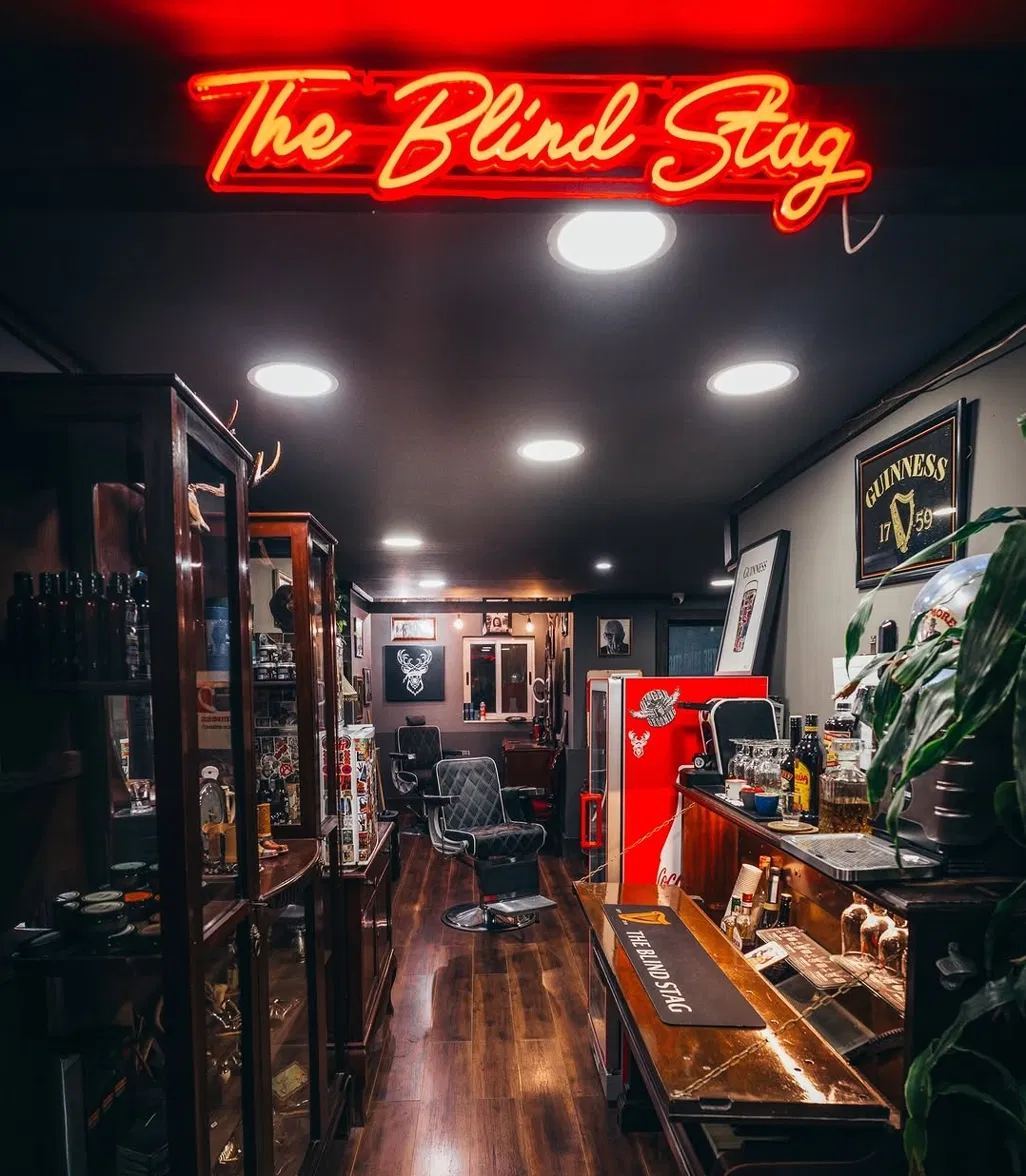 The Blind Stag neon sign and interior at The Blind Stag Barber Spinola Bay