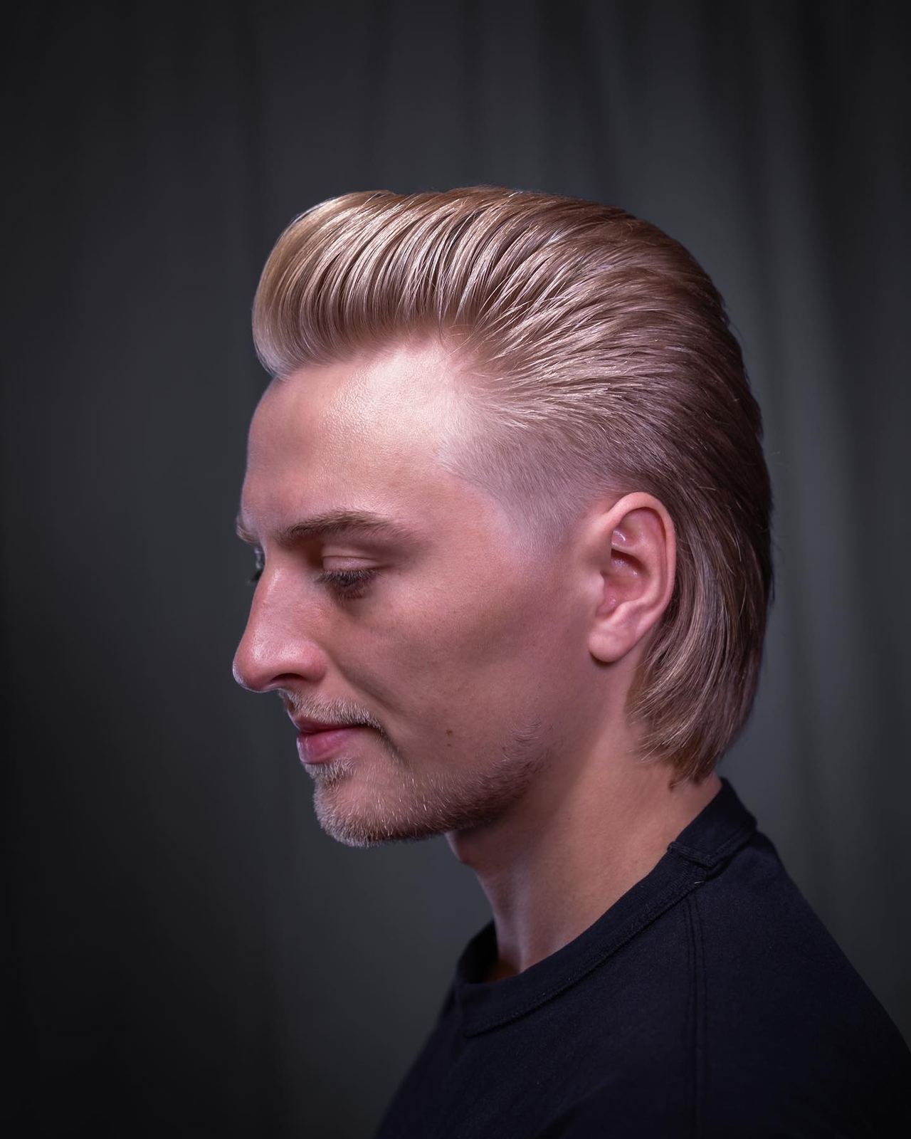 Slicked back hairstyle at The Blind Stag Barber